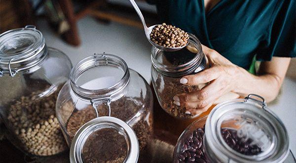 Person fills lentils into a reusable container